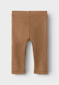 Leggings marron à côtes avec une taille élastique. Ils ont une coupe ajustée et sont fabriqués dans un tissu doux et texturé. Présentent des bords ourlés nets.