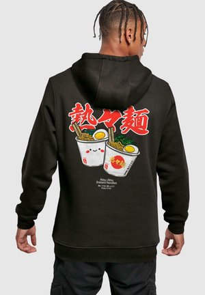 Black hoodie featuring colorful graphic design of two noodle cups with chopsticks and eggs, includes text "Atsui-Atsu Instant Noodles."