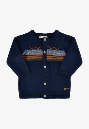 Marineblå strikket cardigan med lange ærmer, knaplukning og flerfarvede vandrette striber med orange, grønne og blå accenter.