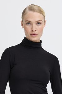 Black turtleneck top with long sleeves, made of smooth, stretchy fabric. The design is fitted with a high collar and minimal seams.