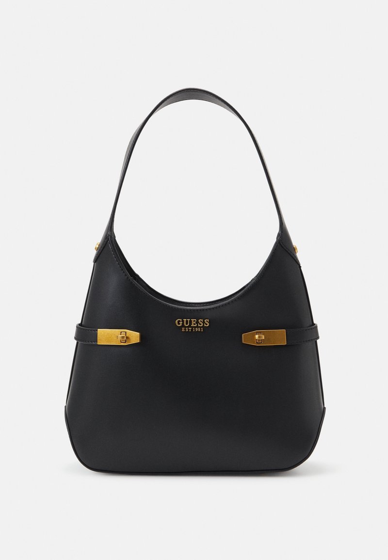 Sac à main Guess noir avec une seule bandoulière, boucles dorées, et logo "GUESS EST 1981" au centre avant.