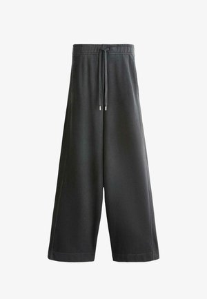 Čierne nohavice s širokými nohavicami, elastickým pásom a dlhými šnúrkami, vyrobené z mäkkej tkaniny.