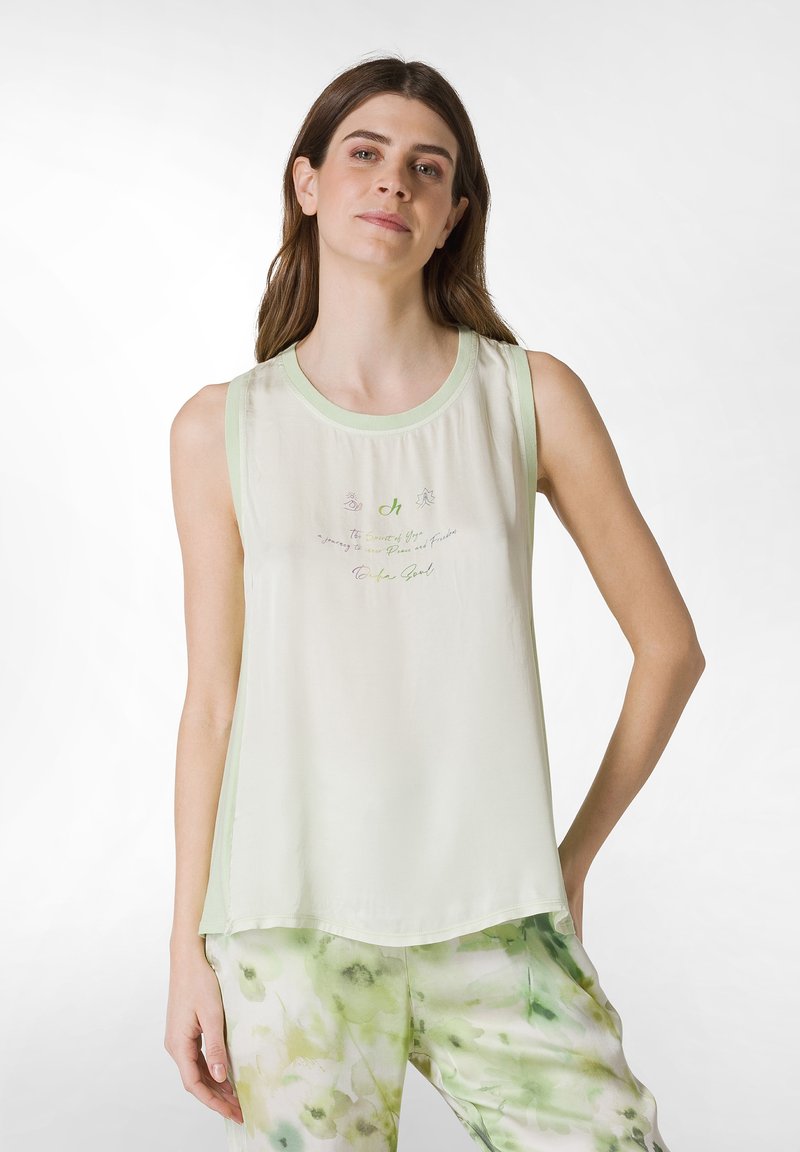 Lysegrønt ærmeløst top med rund halsudskæring, der har broderet tekst og finurlige designs. Det har en løs pasform og en glat struktur.