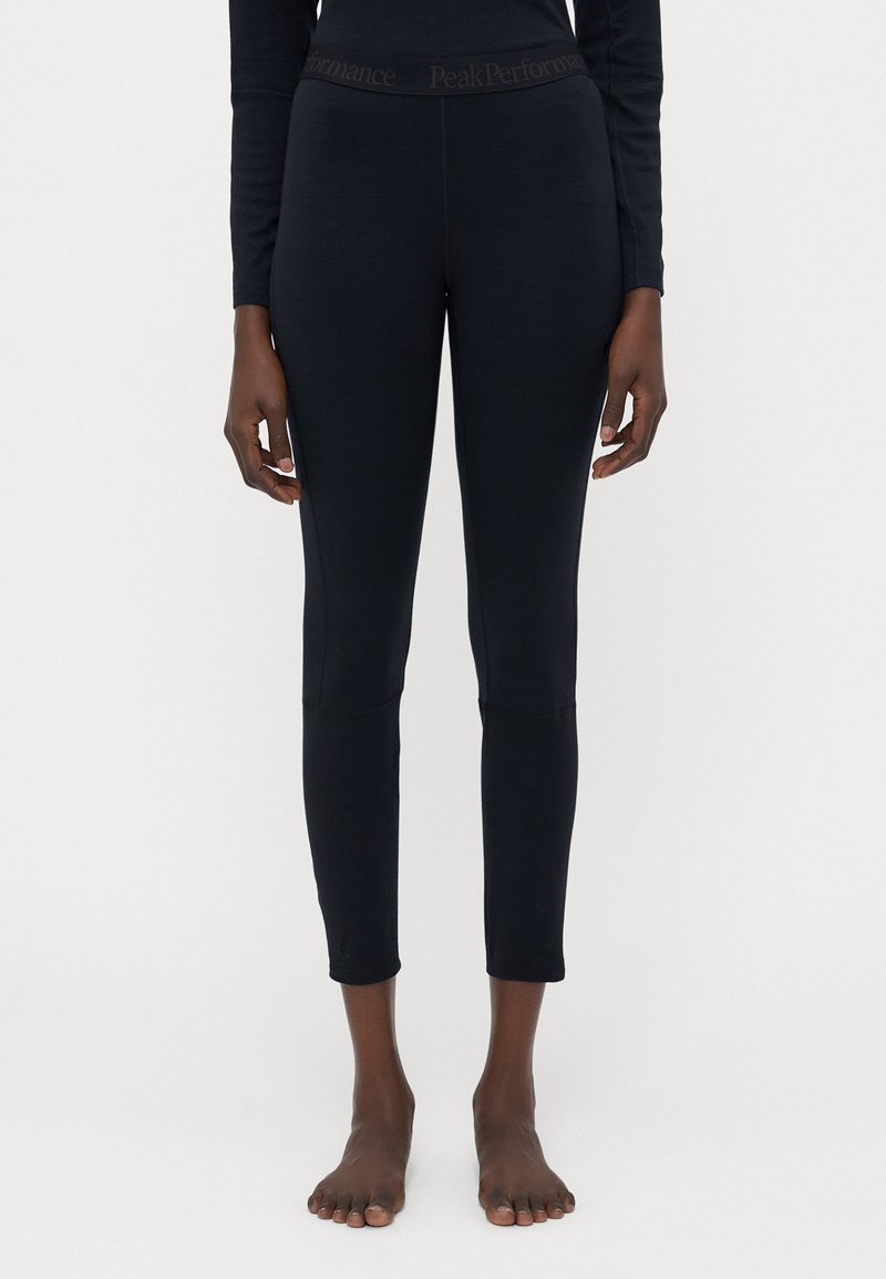 Leggings navy avec une taille haute élastique portant la marque "PeakPerformance", fabriqués dans un tissu lisse, longueur cheville avec une coupe ajustée.