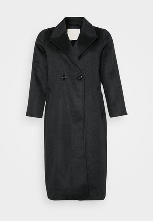 Cappotto doppio petto in misto lana nera con ampio colletto, maniche lunghe e due grandi bottoni neri. Presenta una linea dritta e tasche laterali.