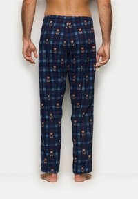 Granatowe piżamowe spodnie w kratę wykonane z miękkiego materiału, z wzorem w niedźwiedzie w brązowym i pomarańczowym kolorze. Luźny krój z elastycznym paskiem w talii.
