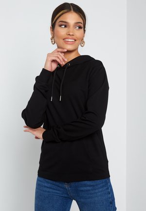 Black hooded sweatshirt with long sleeves, drawstring detail, and kangaroo pocket. Fabric appears soft, medium-weight, and untextured.