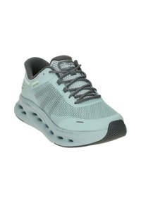 Light blue running shoe with mesh upper, gray accents, and thick midsole featuring ventilation holes. Includes laces and logo on tongue.