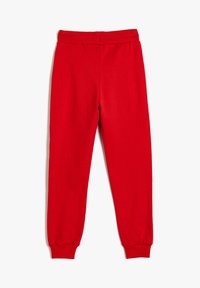 Röda bomulls joggingsbyxor med elastisk midja och cuffade anklar, med en slät textur och enfärgad utan mönster.