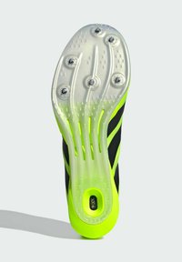 Black and neon green athletic shoe sole with a textured, translucent design; features six detachable studs for traction.