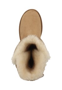 Tan suede boot with a rounded shape, featuring a soft, white shearling lining. The opening is wide, showing the inner texture and material.
