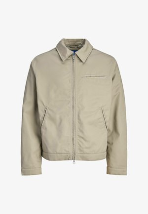 Beige zip-up jacket with pointed collar, two slant side pockets, and a horizontal chest pocket, displayed on a plain white background.