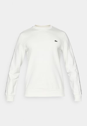 White sweatshirt with long sleeves, crew neck, and green logo. Features striped accents along sleeves and ribbed cuffs for a modern look.