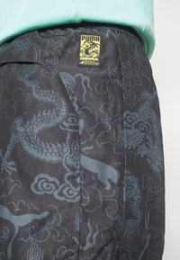 Puma STAPLE PANTS - Træningsbukser - black
