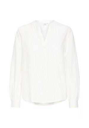Bílá dlouhá košile s výstřihem do V, zapínáním na knoflíky a jemnými vertikálními pruhy. Vyrobena z lehkého materiálu s volnějším střihem.