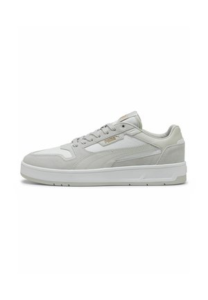 Gray sneaker featuring a combination of leather and suede materials, flat white sole, padded collar, and gold logo accents.