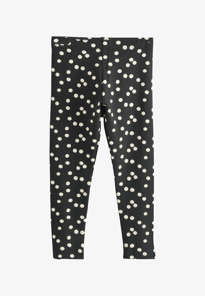 Schwarze Leggings mit weißen Punkten, aus elastischem Stoff gefertigt, mit einem elastischen Bund und einem schlanken, eng anliegenden Schnitt.