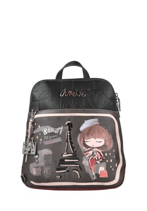 Mochila negra de imitación cuero con textura en relieve, que presenta un diseño de una chica de dibujos animados y la Torre Eiffel, cierre plateado y etiquetas decorativas.