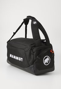 Black duffel bag with padded handles, featuring a front zip pocket, Mammut logo, and orange accents on zipper pull. Textured nylon material.