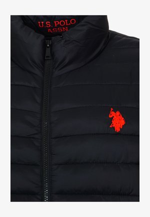 Black quilted jacket with front zipper, featuring red U.S. Polo Assn. text inside collar and red horse rider logo on chest.