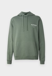 Green hoodie made of soft fabric, featuring a front pouch pocket, drawstring hood, and white text logo on the chest.