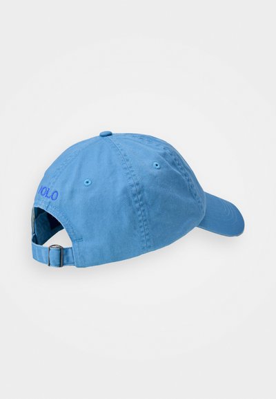 Light blue cotton cap with a curved visor, adjustable strap, and embroidered logo on the back. Smooth texture and casual design.