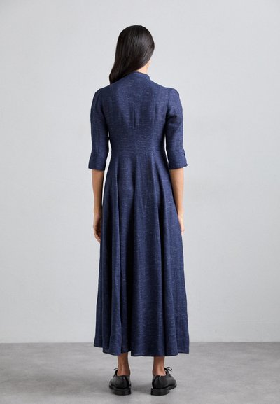 Navy blue, knee-length dress with a fitted bodice, three-quarter sleeves, and a flared skirt. Crafted from textured, lightweight fabric.