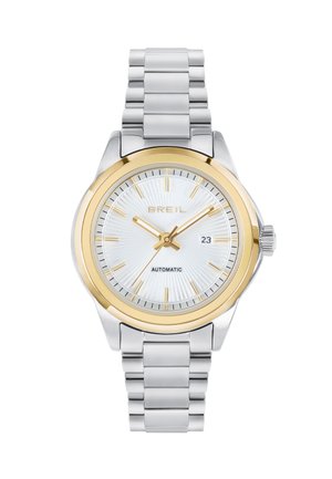 Sølv og guld automatisk ur med en struktureret hvid urskive, guldtallene og et bånd i rustfrit stål med polerede led.