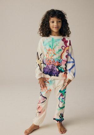 Sweatshirt- und Hosen-Set mit Graffiti-Druck, das lebendige Farben auf einem cremefarbenen Hintergrund zeigt. Hergestellt aus weichem Baumwollmaterial mit elastischen Bündchen.
