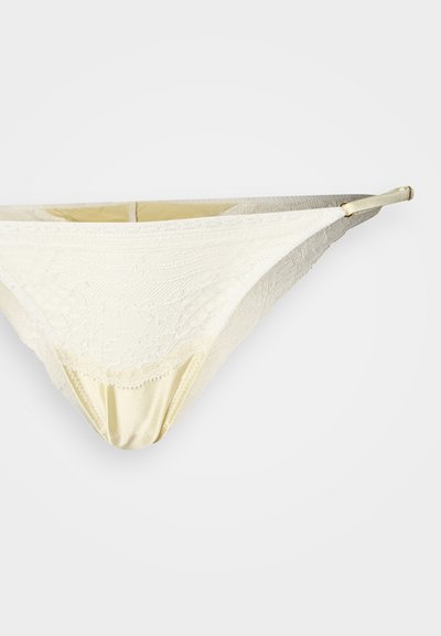 Pitsist ja satiinist kreemjas bikiinipüksid keeruka lillemustriga, reguleeritavate rihmade ja pehme tekstuuriga. Elegantne ja vormis disain.