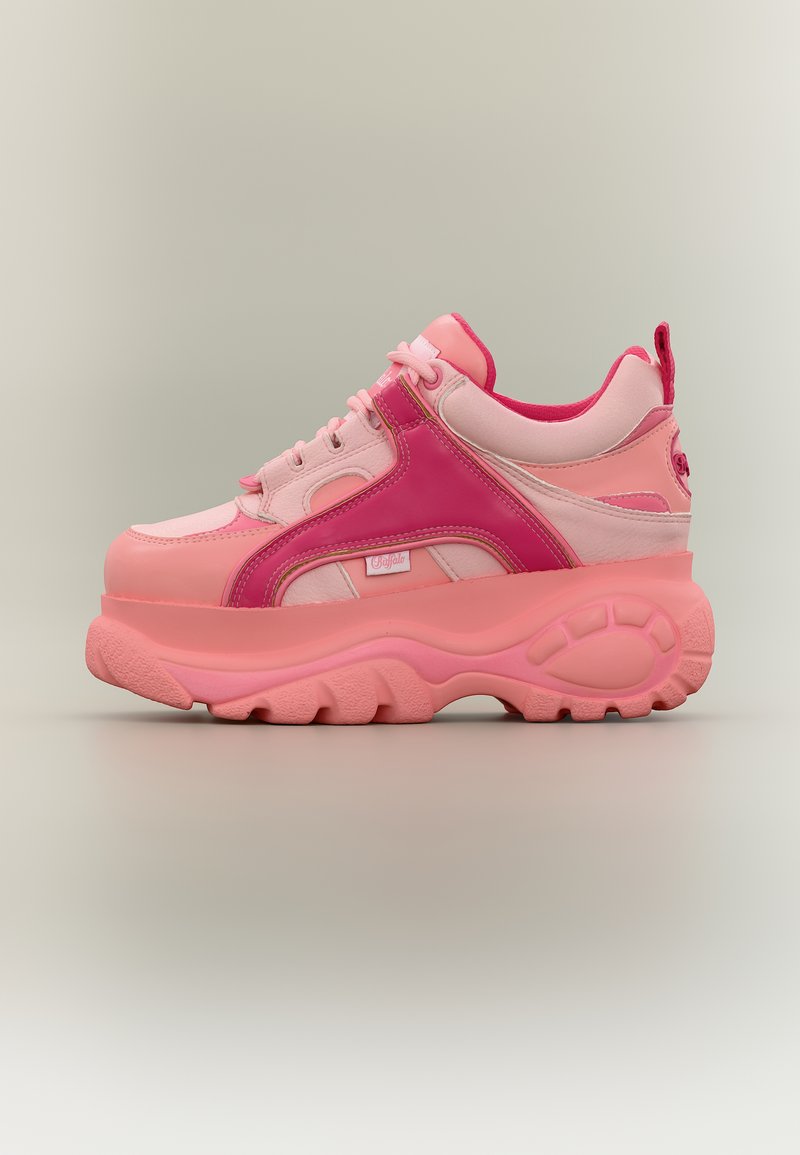 Χοντρό αθλητικό παπούτσι με πλατφόρμα σε αποχρώσεις του ροζ, με παχιά υφή στη σόλα, μπροστινό κορδόνι και επενδεδυμένο κολάρο, εμφανίζεται σε πλάγια όψη σε ουδέτερο φόντο.