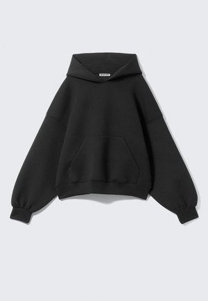 Black oversized hoodie made of soft fabric, featuring a large front pocket, long balloon sleeves, and a drawstring hood.