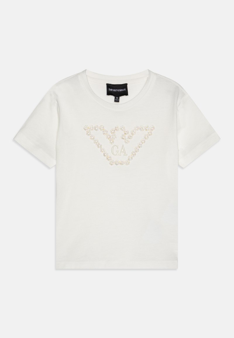 Balts kokvilnas T-krekls ar īsām piedurknēm, kas rotāts ar dekoratīvu kristālu rakstu, veidojot logo dizainu priekšpusē. Klasisks apaļais kakla izgriezums.