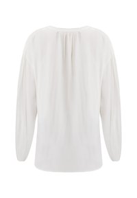 Blusa bianca con un fit rilassato, maniche lunghe con dettagli arricciati e una texture liscia e leggera. Semplice scollo rotondo.