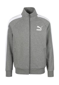 Grijze ritsjack gemaakt van zachte stof, met witte schouderstrepen, hoge kraag, voorzakken en een klein wit Puma-logo.