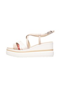 Wedge sandals with beige strappy design, white patent and red accents, cushioned sole, adjustable ankle strap, and a textured white base.