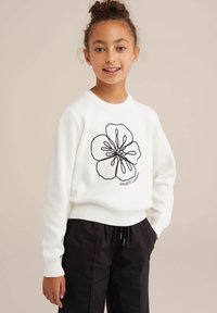White knit sweater featuring black floral embroidery with the text "COLLECT FLOWERS." Round neckline and ribbed cuffs, paired with black pants.
