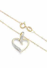 Zelta tonī rotas kaklarota, kurai ir sirds piekariņš ar izliektu sudraba akcentu un iestrādātiem caurspīdīgiem kristāliem, pabeigta ar omāru sprādzi.