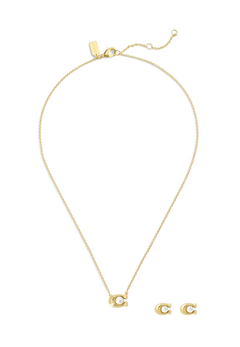 Ensemble de bijoux dorés comprenant un collier délicat avec une chaîne et un pendentif rond contenant une perle, ainsi que des boucles d'oreilles à puce en perle assorties.