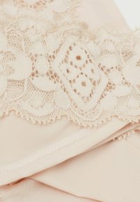 Lace met bloemenpatronen in zachtroze over gladde satijnen stof, met gegolfde randen en een delicate textuur.