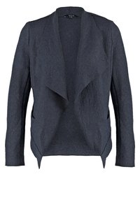 Blazer gris foncé en tissu texturé, avec un devant ouvert, des manches longues et des poches latérales. Design décontracté à coupe ample.