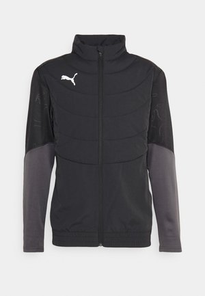 Zwarte zip-up jack met hoge kraag, gevoerd bovenstuk en grijze mouwen. Bevat een wit logo op de borst en een elastische zoom.