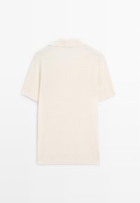 Korte mouw polo shirt in crème met een gladde textuur en een klassieke kraag. Heeft raglanmouwen en subtiele ribbelaccenten.