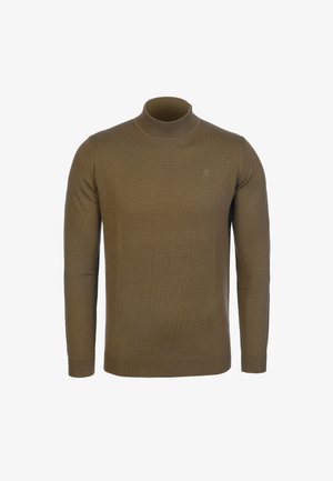 Ruskea pitkähihaista poolopaitaa muistuttava neule, jossa on vasemmassa rinnassa hienovaraisesti kirjailtu logo, esillä neutraalilla taustalla.