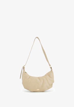 Beige leather shoulder bag with a curved shape, textured surface, and a detachable strap. Features a subtle gold hardware detail.