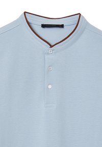 Maglietta henley a maniche corte di colore azzurro con colletto a bordo marrone, due bottoni bianchi sulla patta e tessuto strutturato. Taglia XL.