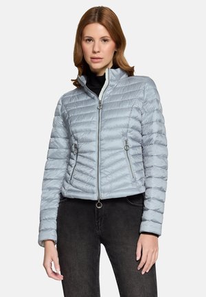 Light blue puffer jacket with horizontal quilted pattern, two zippered front pockets, high collar, and silver zipper detailing.