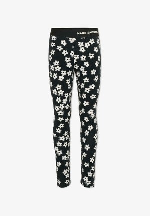 Leggings neri con motivo floreale bianco, dotati di una fascia elastica con l'etichetta "MARC JACOBS." Tessuto morbido con una texture liscia.