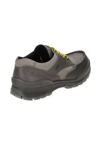 Gray leather shoe with black and yellow laces, a sturdy rubber sole, and reinforced stitching. Rear shows logo and textured details.