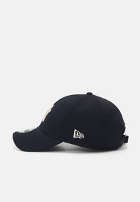 Cappellino da baseball navy realizzato in tessuto testurizzato, con logo ricamato in crema. Strap regolabile sul retro per personalizzare la taglia.